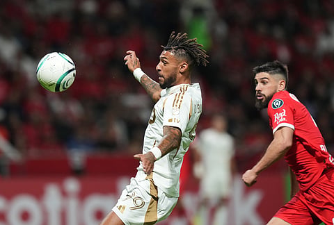 Denis Bouanga of the United States' Los Angeles FC, left, goes for the ball followed by Bruno Mendez of Mexico's Toluca during a CONCACAF Champions Cup second leg semifinal soccer match in Toluca, Mexico.