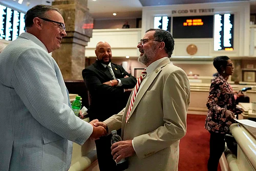 PTI : Republican state Rep. Chris Pringle, centre, speaks to a colleague on the House floor during a special session of the Alabama Legislature.