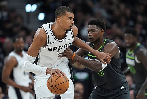 San Antonio Spurs forward Victor Wembanyama (1) drives against Minnesota Timberwolves guard Anthony Edwards (5) during the first half in Game 2 of a second-round NBA playoffs basketball series in San Antonio.