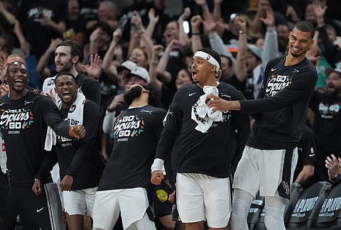San Antonio Spurs forward Victor Wembanyama, right, and forward Keldon Johnson, second from right, reacts to a play with teammates during the second half in Game 2 of a second-round NBA playoffs basketball series against the Minnesota Timberwolves in San Antonio.