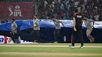 AP : LSG vs RCB, IPL 2026: Ground staff pull rain covers to the field as it drizzles during the Indian Premier League cricket match.