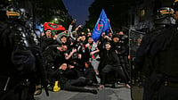 | Photo: AP/EMMA DA SILVA : PSG supporters face French riot police as they celebrate Paris Saint-Germain's Champions League semifinal victory over Bayern Munich at Place de la Concorde in Paris, Thursday, May 7, 2026. 