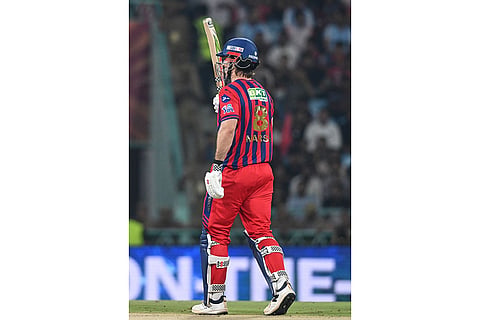 Lucknow Super Giants' Mitchell Marsh celebrates his fifty runs during the Indian Premier League cricket match between Royal Challengers Bengaluru and Lucknow Super Giants in Lucknow, India.