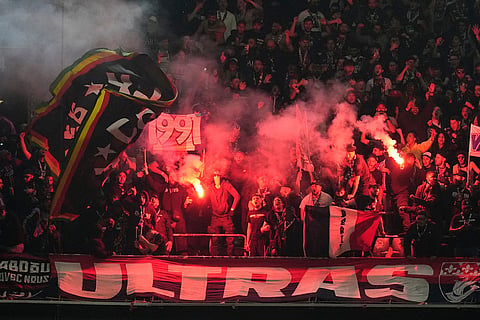 Fans cheer during the Champions League semifinal second leg soccer match between Bayern Munich and Paris Saint Germain in Munich, Germany.