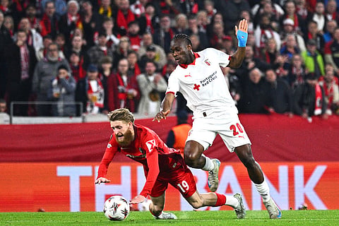 Braga's Mario Dorgeles, right, fouls Freiburg's Jan-Niklas Beste during the Europa League second leg semifinal soccer match between SC Freiburg  and SC Braga in Freiburg, Germany.