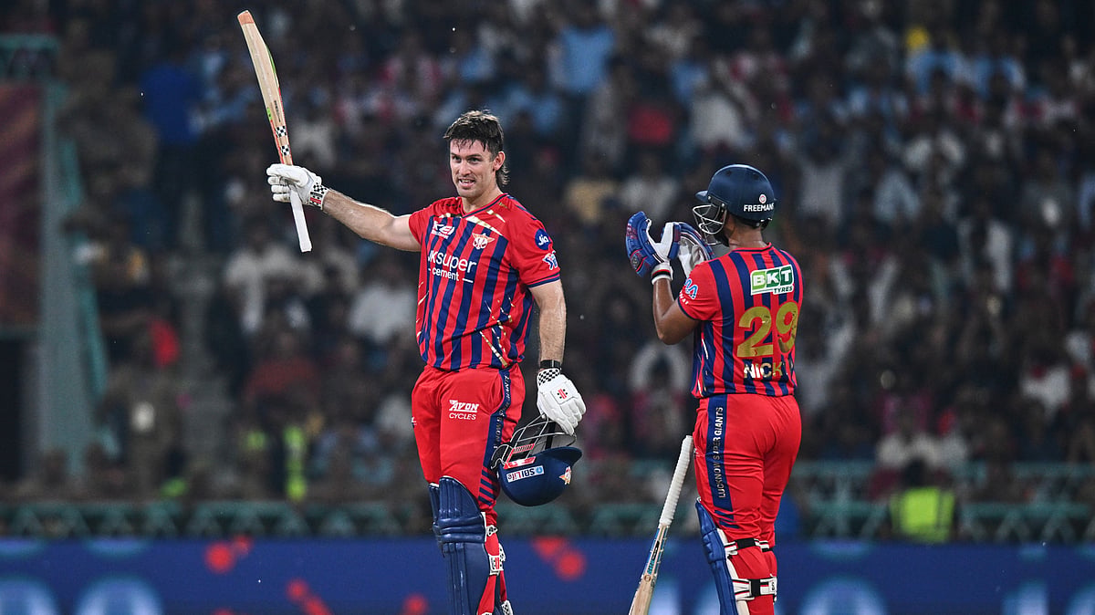 Lucknow Super Giants' Mitchell Marsh, left, celebrates his century with his batting partner Nicholas Pooran during the Indian Premier League cricket match between Royal Challengers Bengaluru and Lucknow Super Giants in Lucknow, India, Thursday, May 7, 2026. - (AP Photo)