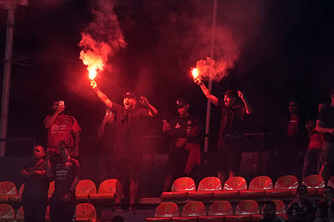 Fans of Colombia's Independiente Medellin cheer and light flares as they wait for the start of a Copa Libertadores Group A soccer match between Independiente Medellinin and Brazil's Flamengo in Medellin, Colombia.
