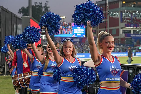 Delhi Capitals' cheerleaders perform during the toss before an Indian Premier League (IPL) 2026 T20 cricket match between Delhi Capitals and Kolkata Knight Riders, in New Delhi.