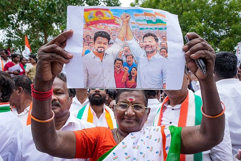 A Congress worker during a protest against the Governor over not inviting Tamilaga Vettri Kazhagam (TVK) chief Vijay to form the government, in Chennai. - | Photo: PTI/R Senthilkumar