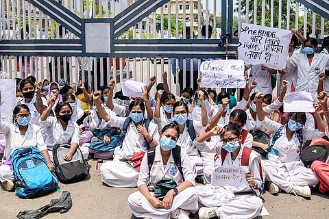 Students of Indira Gandhi Institute of Medical Sciences hold placards and stage a protest at the main gate of the institution, accusing senior college officials of harassment, unfair academic practices, and administrative intimidation, in Patna, Bihar.