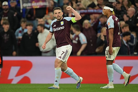 Aston Villa's John McGinn celebrates after scoring during the Europa League second-leg semifinal soccer match between Aston Villa and Nottingham in Birmingham, England.