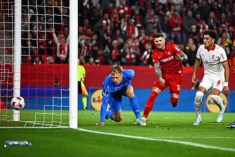 Freiburg's Lukas Kubler, center, scores a goal during the Europa League second leg semifinal soccer match between SC Freiburg  and SC Braga in Freiburg, Germany.