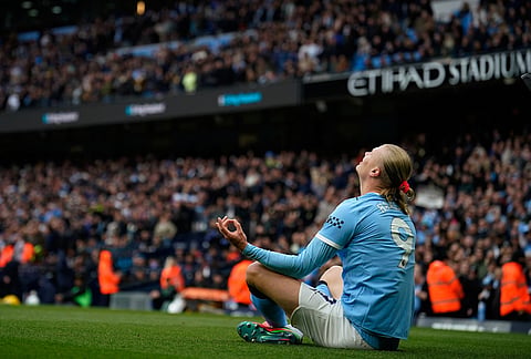 Manchester City's Erling Haaland celebrates after scoring his side's opening goalduring the English Premier League soccer match between Manchester City and Brentford in Manchester.
