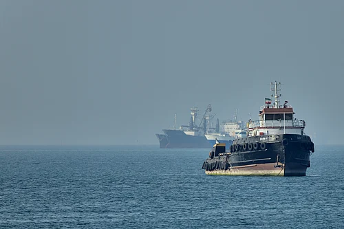 AP : An Iranian tugboat floats in the foreground as cargo ships sit at anchor in the Strait of Hormuz off Bandar Abbas, Iran, Monday, May 4, 2026.