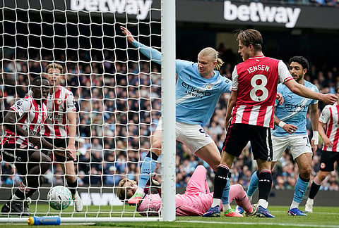 Manchester City's Erling Haaland, center, scores his side's second goal during the English Premier League soccer match between Manchester City and Brentford in Manchester.