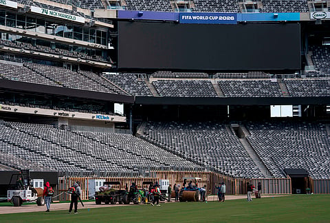 Workers install grass during the pitch installation for FIFA World Cup 2026 at NYNJ Stadium in East Rutherford, New Jersey.