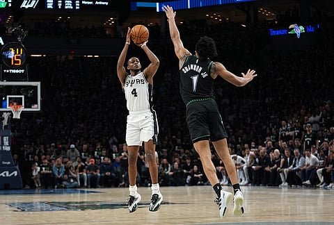 San Antonio Spurs guard De'aaron Fox (4) shoots against Minnesota Timberwolves guard Terrence Shannon Jr. (1) during the second half of Game 3 of a NBA basketball second-round playoff series in Minneapolis.