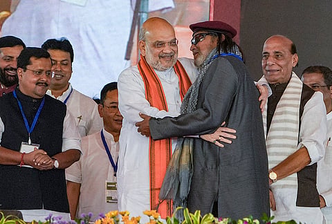 Union Minister Amit Shah and BJP leader Mithun Chakraborty during the swearing-in ceremony of party leader Suvendu Adhikari, unseen, as he becomes West Bengal's Chief Minister, in Kolkata, West Bengal. Defence Minister Rajnath Singh and party's National President Nitin Nabin are also seen. 