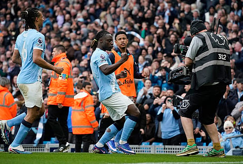 Manchester City's Jeremy Doku, center, celebrates after scoring the opening goal during the English Premier League soccer match between Manchester City and Brentford in Manchester.