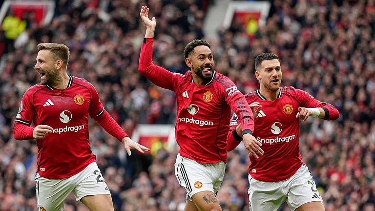 Matheus Cunha, centre, celebrates with teammates after scoring his side's opening goal during the English Premier League match between Manchester United and Liverpool in Manchester. - Photo: AP/Dave Thompson