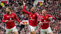 Photo: AP/Dave Thompson : Matheus Cunha, centre, celebrates with teammates after scoring his side's opening goal during the English Premier League match between Manchester United and Liverpool in Manchester.
