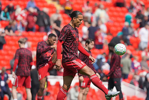 Liverpool's Virgil van Dijk warms up for the Premier League soccer match between Liverpool and Chelsea in Liverpool, England.