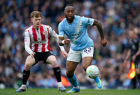 Manchester City's Antoine Semenyo, right, and Brentford's Keane Lewis-Potter challenge for the ball during the English Premier League soccer match between Manchester City and Brentford in Manchester.