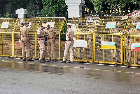 Police personnel keep vigil outside Lok Bhavan ahead of the Tamil Nadu government formation, in Chennai.