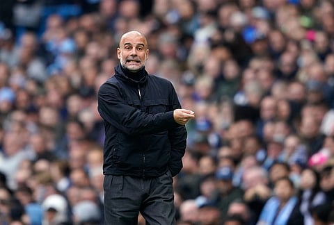 Manchester City's head coach Pep Guardiola gives instructions to his players during the English Premier League soccer match between Manchester City and Brentford in Manchester.