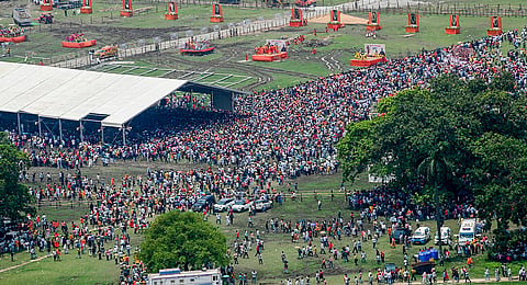 People gather at Brigade Parade Ground during the swearing-in ceremony of BJP leader Suvendu Adhikari as he becomes West Bengal's first party Chief Minister, in Kolkata, West Bengal.
