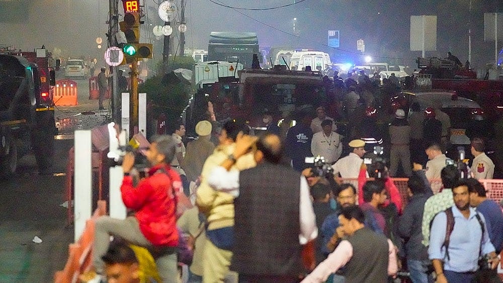Emergency services personnel at the spot after a blast occurred in a parked car near Red Fort, leaving multiple vehicles in flames, in New Delhi. - | Photo: PTI/Salman Ali