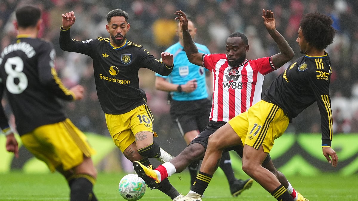 Sunderland's Lutsharel Geertruida is challenged by Manchester United's Matheus Cunha and Joshua Zirkzee, right, during the English Premier League. - Owen Humphreys/PA via AP
