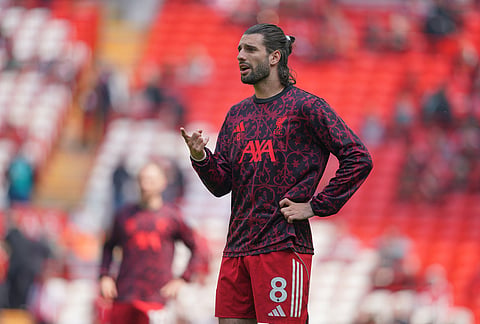 Liverpool's Dominik Szoboszlai warms up for the Premier League soccer match between Liverpool and Chelsea in Liverpool, England.