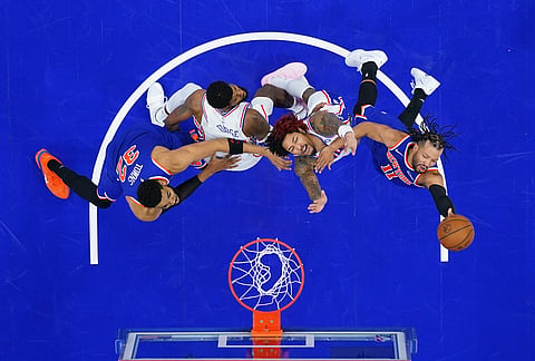 New York Knicks' Jalen Brunson, from right, goes up for a shot against Philadelphia 76ers' Kelly Oubre Jr. and Paul George as Karl-Anthony Towns defends during the second half of Game 3 in a second-round NBA basketball playoff series in Philadelphia.