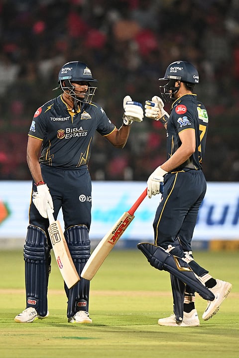 Gujarat Titans' Sai Sudharsan, left, tosses with Shubman Gill during the Indian Premier League cricket match between Rajasthan Royals and Gujarat Titans in Jaipur.
