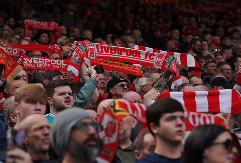 Liverpool fans cheer before the Premier League soccer match between Liverpool and Chelsea in Liverpool, England.
