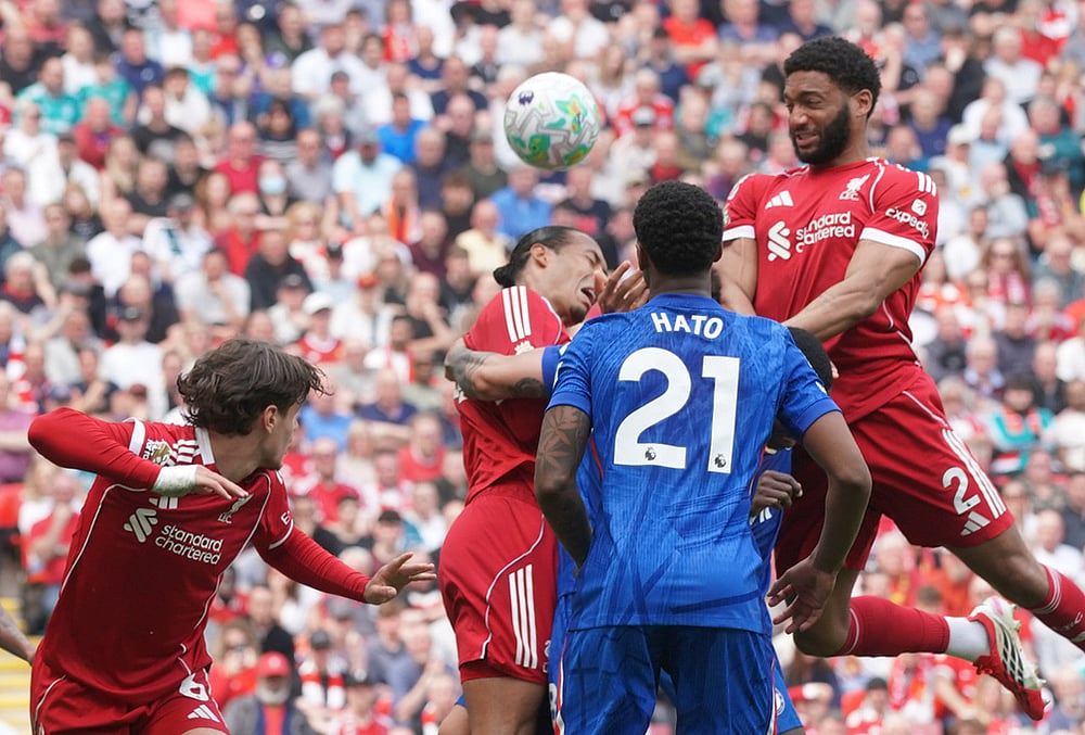 Liverpool's Joe Gomez shoots a header during the Premier League soccer match between Liverpool and Chelsea in Liverpool, England. - | Photo: AP/Ian Hodgson