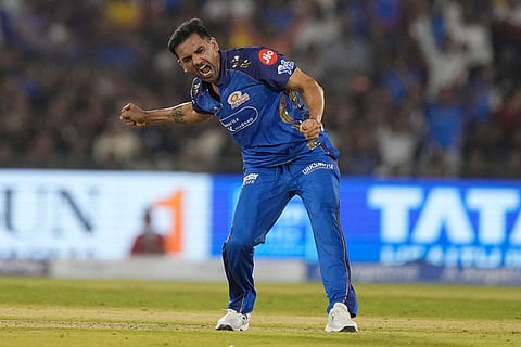 Mumbai Indians' Deepak Chahar celebrates the wicket of Royal Challengers Bengaluru's Devdutt Padikkal during the Indian Premier League cricket match between Royal Challengers Bengaluru and Mumbai Indians in Raipur, India.