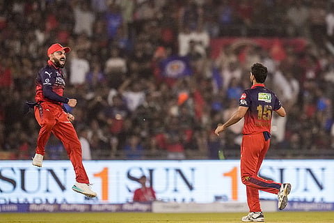 Royal Challengers Bengaluru's Bhuvneshwar Kumar celebrates with teammate Virat Kohli, left, after he dismisses Mumbai Indians' Suryakumar Yadav during an Indian Premier League (IPL) 2026 T20 cricket match between Royal Challengers Bengaluru and Mumbai Indians, in Raipur, Chattisgarh.