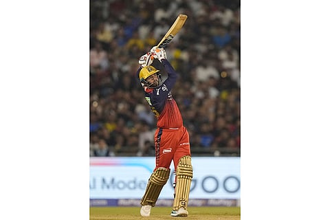 Royal Challengers Bengaluru's Jitesh Sharma hits a six during the Indian Premier League cricket match between Royal Challengers Bengaluru and Mumbai Indians in Raipur, India.