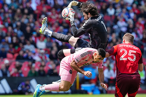 Toronto FC goalkeeper Luka Gavran (1) collides with Inter Miami CF forward German Berterame (19) as Toronto's Walker Zimmerman (25) looks on during first half MLS soccer in Toronto.
