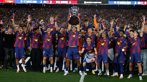 AP Photo : Barcelona players lift the trophy after winning the Spanish La Liga El Clasico match against Real Madrid to clinch the Spanish league title in Barcelona, Spain, Sunday.