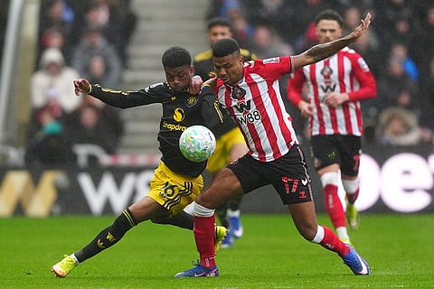 Manchester United's Amad Diallo, left, and Sunderland's Reinildo Mandava battle for the ball during the English Premier League soccer match between Sunderland and Manchester United in Sunderland, England.