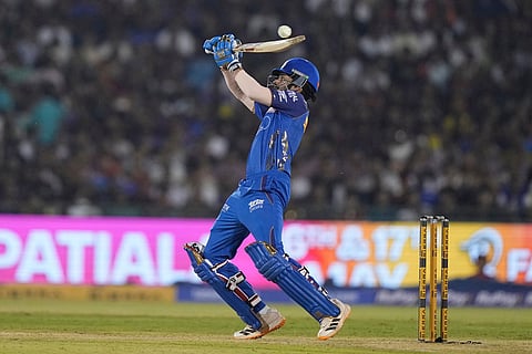 Mumbai Indians' Raj Angad Bawa hits a boundary during the Indian Premier League cricket match between Royal Challengers Bengaluru and Mumbai Indians in Raipur, India.