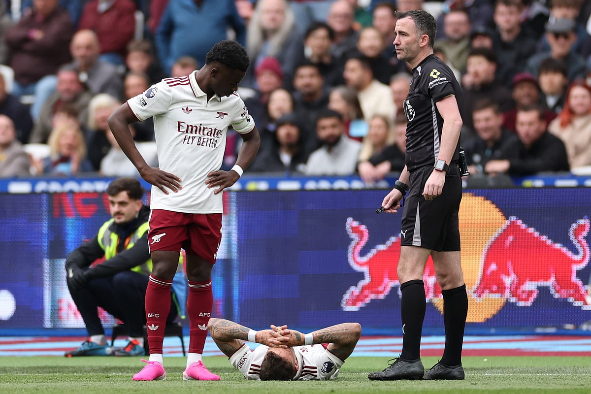 Arsenal's Ben White reacts to an injury during the Premier League soccer match between West Ham and Arsenal in London, Sunday.