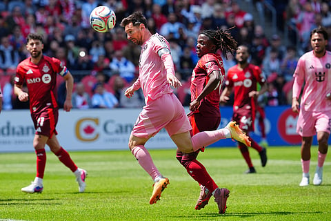 Inter Miami CF midfielder Lionel Messi (10) takes a header to shoot on goal as Toronto FC midfielder Malik Henry (78) looks on during first half MLS soccer in Toronto.