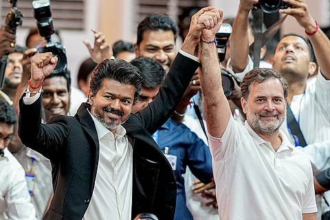 Newly-elected Tamil Nadu Chief Minister and Tamilaga Vettri Kazhagam (TVK) chief C Joseph Vijay joins hands with Congress MP and Lok Sabha LoP Rahul Gandhi during the former's swearing-in ceremony, at Jawaharlal Nehru Stadium, in Chennai.