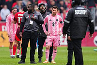 | Photo: Frank Gunn /The Canadian Press via AP : Inter Miami CF midfielder Lionel Messi (10) is surrounded by security on the field after multiple fans ran onto the pitch during second half MLS soccer against Toronto FC, in Toronto .