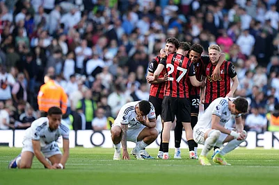 | Photo: Ben Whitley/PA via AP : Bournemouth players, standing, celebrate at the end of the English Premier League soccer match between Fulham and AFC Bournemouth in London.