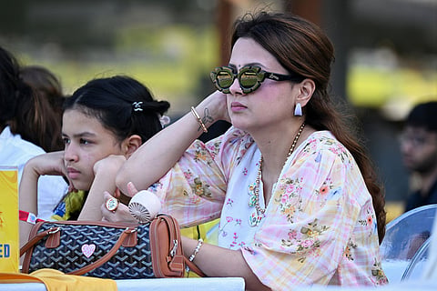 Former Indian international cricketer M S Dhoni's wife Sakshi Singh with her daughter, left, watches the Indian Premier League cricket match between Chennai Super Kings and Lucknow Super Giants in Chennai, India.